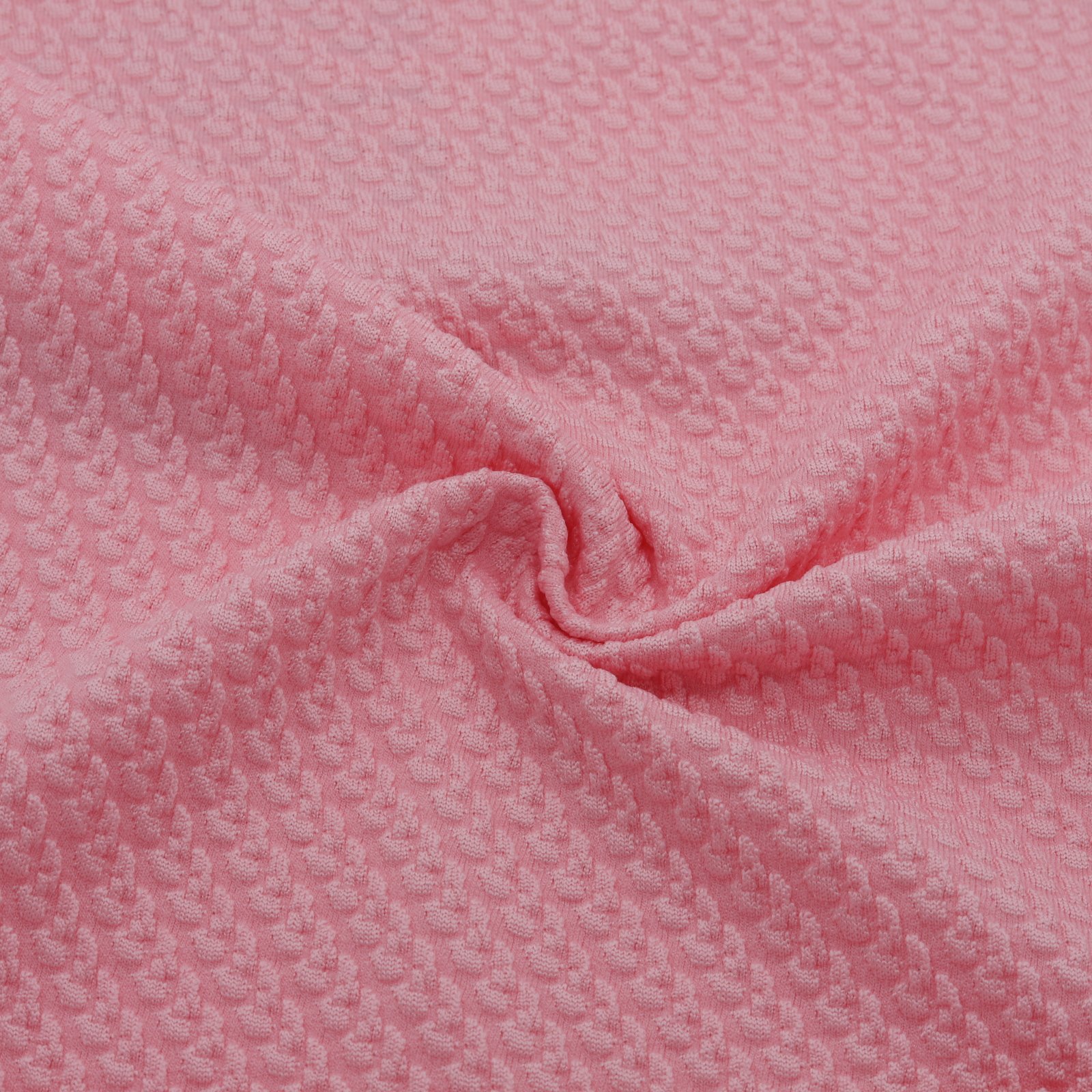 Tissu jacquard rose texturé extensible au relief discret et régulier